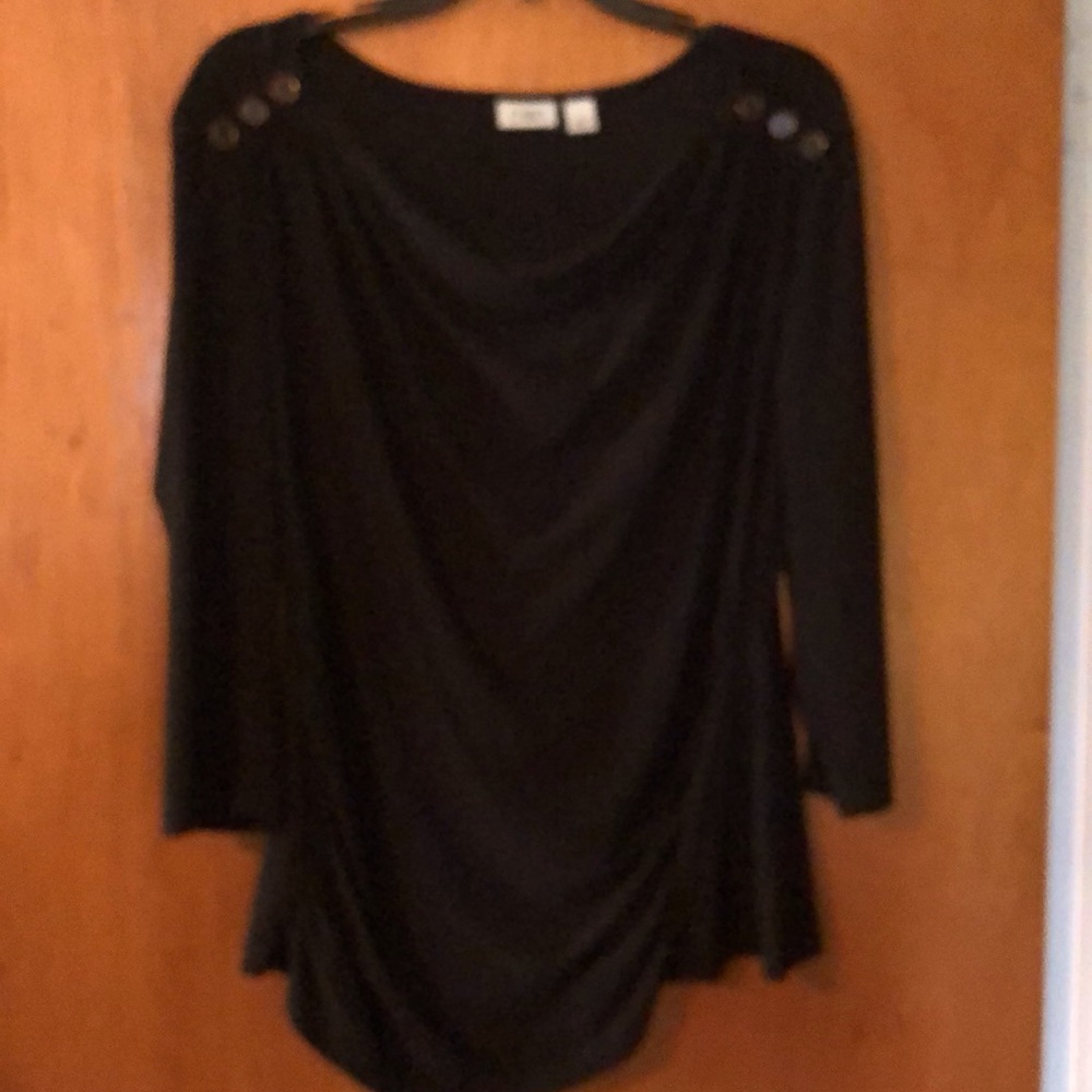 Black polyester spandex. Has gold buttons on shoulders.